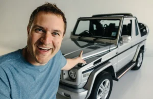 Doug DeMuro is waving at his Jeep.