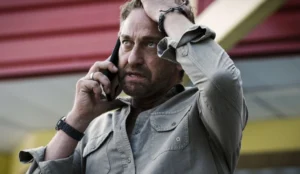Gerard Butler is talking on the phone.