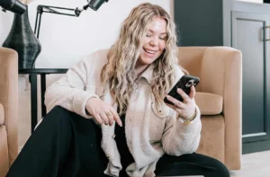 Kellyanne Lowry is using her mobile phone.