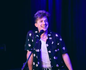 Charlie Puth is laughing while singing the song.
