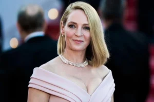 Uma Thurman is laughing.