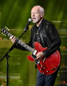 Peter Frampton is singing while playing the guitar.