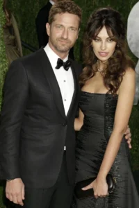 Gerard Butler stands with his wife.