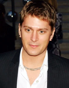 Rob Thomas is looking down.