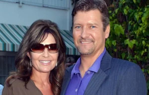 Todd Palin stands with his wife.
