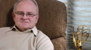 Gary Berghoff is sitting on the couch.