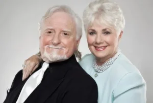 Shirley Jones stands with her husband.