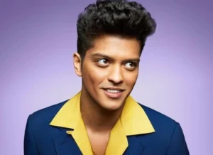 Bruno Mars is smiling.