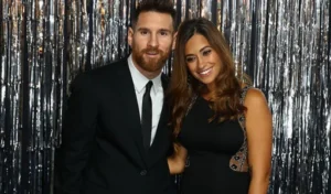 Lionel Messi stands with his wife.