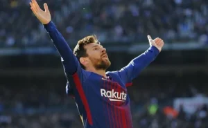 Lionel Messi has his hands raised.