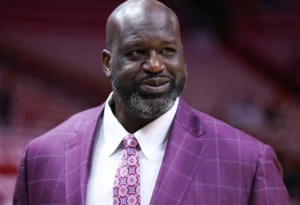 Shaquille O'Neal is smiling.