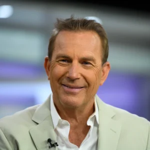 Kevin Costner is laughing.