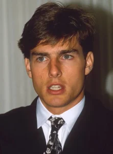 Tom Cruise looks on in surprise.