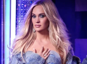 Carrie Underwood has her hand on her chest.