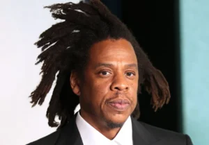 Jay Z stands there worried.