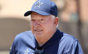 Jerry Jones is sitting outside in the sun.