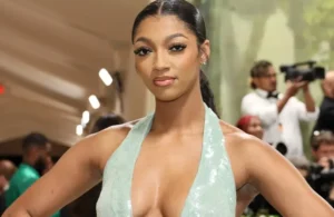 Angel Reese is wearing a blue dress.