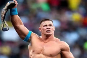 John Cena is holding the belt.