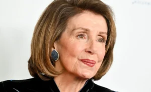 Nancy Pelosi is smiling.