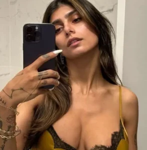 Mia Khalifa is taking a picture on her mobile phone.