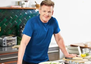 Gordon Ramsay is in the kitchen cooking.