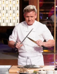 Gordon Ramsay is working in the kitchen.