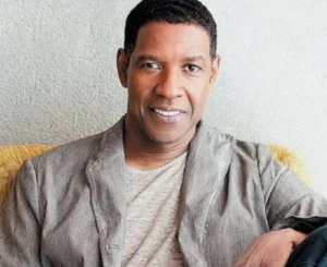 Denzel Washington is sitting there laughing.