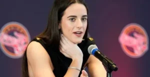 Caitlin Clark is speaking into the mic.