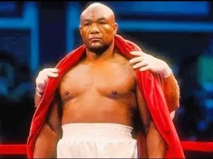 George Foreman stands up for a boxing fight.