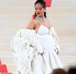 Rihanna is laughing while wearing white.