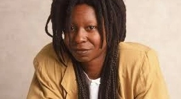 Whoopi Goldberg is laughing.
