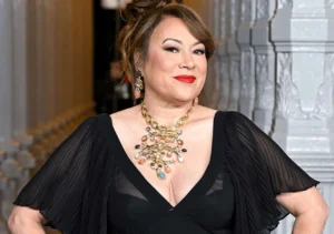 Jennifer Tilly is laughing.