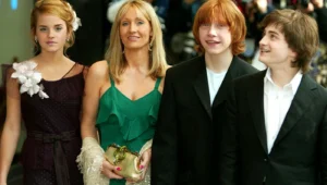 J.K. Rowling stands with the children who played the roles in the film.