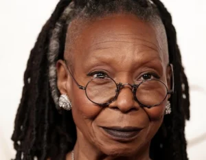 Whoopi Goldberg is laughing.