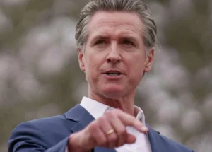 Gavin Newsom is making a hand gesture while speaking.