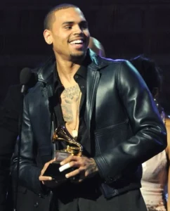 Chris Brown is laughing as he holds up the award.