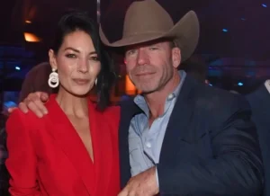 Taylor Sheridan stands with his wife.