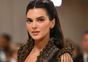 Kendall Jenner is smiling while wearing nice clothes.