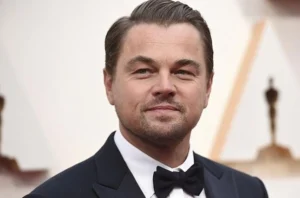 Leonardo DiCaprio is smiling.