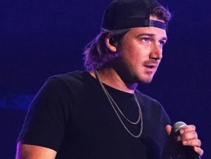 Morgan Wallen stands next to the microphone.