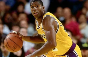 Magic Johnson is running with a basketball.
