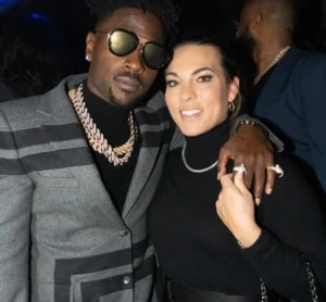 Antonio Brown stands with his hand on the girl's shoulder.