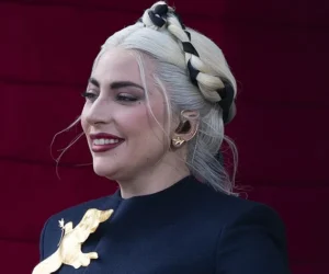 Lady Gaga is laughing while wearing black.