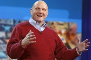 Steve Ballmer in 2025 is shaking hands while talking.