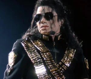 Michael Jackson looks like a girl wearing a black suit.