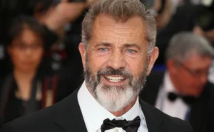 Mel Gibson stands among the people.