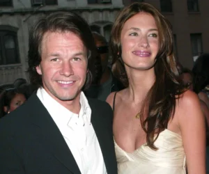 Mark Wahlberg is standing next to the girl, laughing.