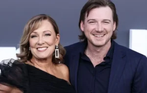 Morgan Wallen is laughing as the woman stands.