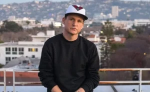 Rob Dyrdek stands on the edge of the roof.