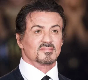 Sylvester Stallone is smiling.